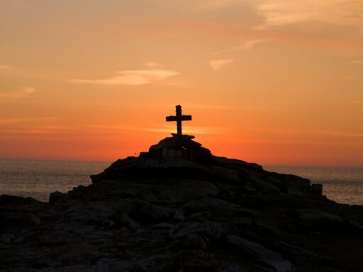 silhueta de uma cruz na montanha